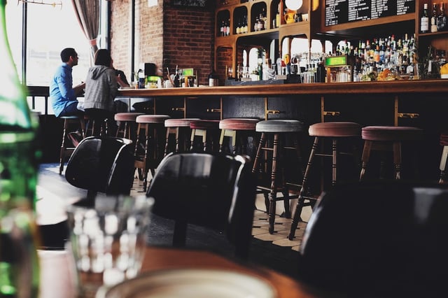 Two people talking at a bar. Talking to customers should be a keystone of any good startup marketing plan. Two people talking at a bar. Talking to customers should be a keystone of any good startup marketing plan.