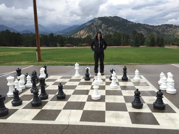An image of a person looking at an oversize chess board. When faced with a lot of sales leads, it can be difficult to tell which is the best path forward.
