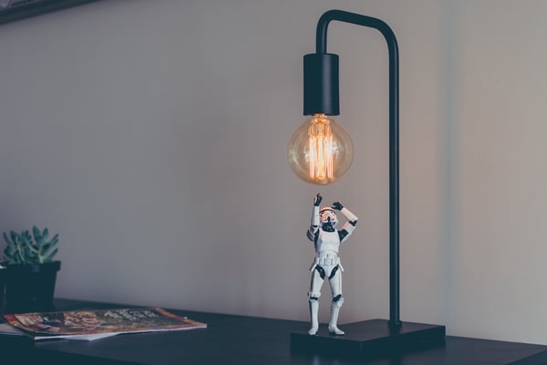 An image of a Storm Trooper figurine and a light. Artificial intelligence - "chatbots" - can help shed light on customer sentiment.