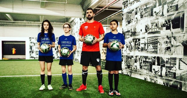 A picture of David Villa and youth soccer players at an Upper 90 Soccer Store. Ben Jata is the Director of Operations for Upper 90 and uses Olark live chat software on the website.